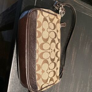 coach shoulder bag w matching wallet brown w the coach logo on it